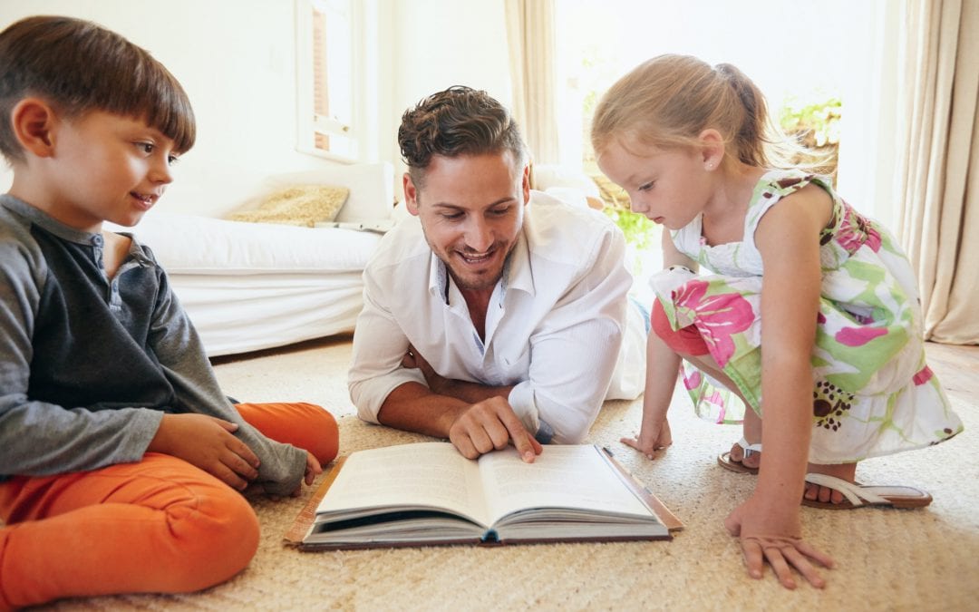 Father reading stories to his children