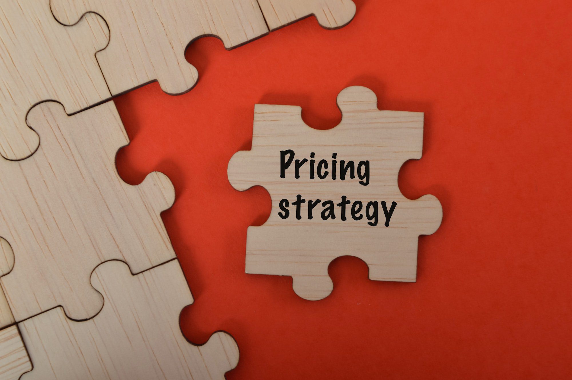 The word PRICING STRATEGY is written on jigsaw puzzle.